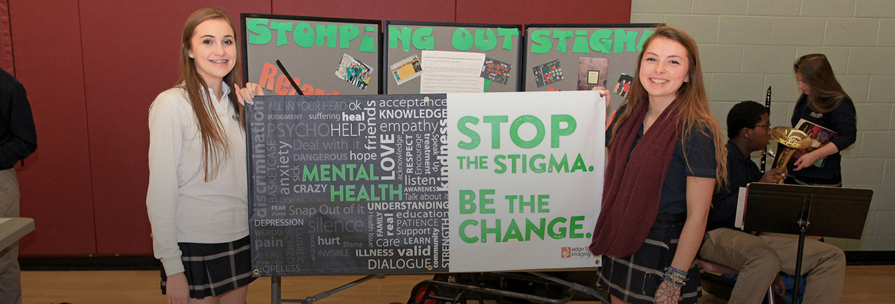 Two girls standing in front of Mental Health display