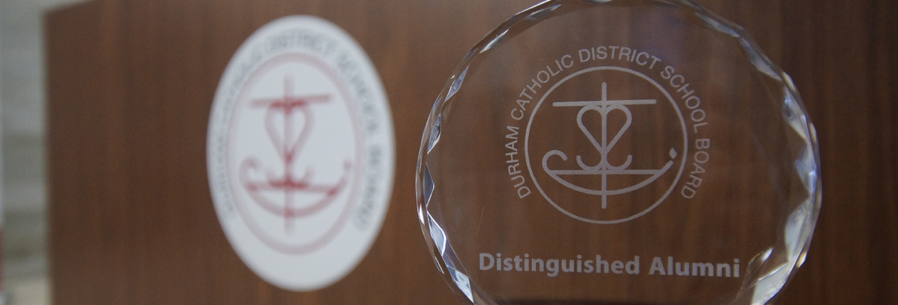 Glass award with Board's logo with words Distinguished Alumni