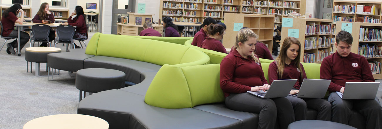 Students sitting in a school's learning commons area