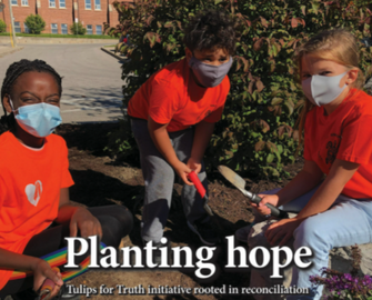 student planting tulips