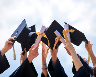 Graduation caps being thrown up in the air