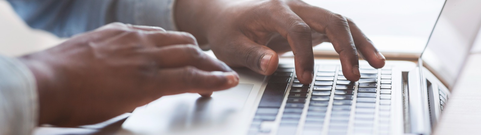 a pair of hands on a laptop keyboard