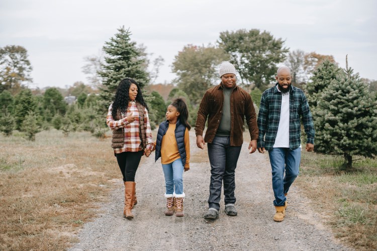 a photo of a family walking outside on a path