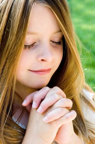 a young girl praying