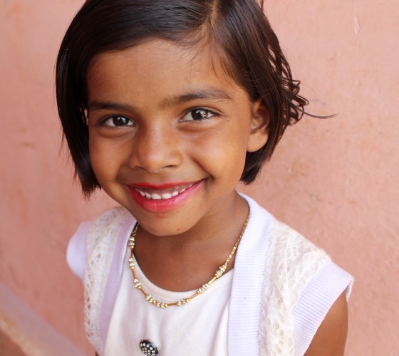 a young girl smiling at the camera
