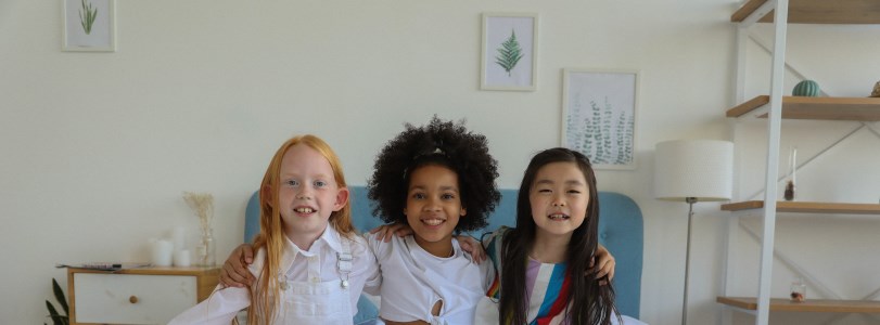 three young girls with their arms around each other