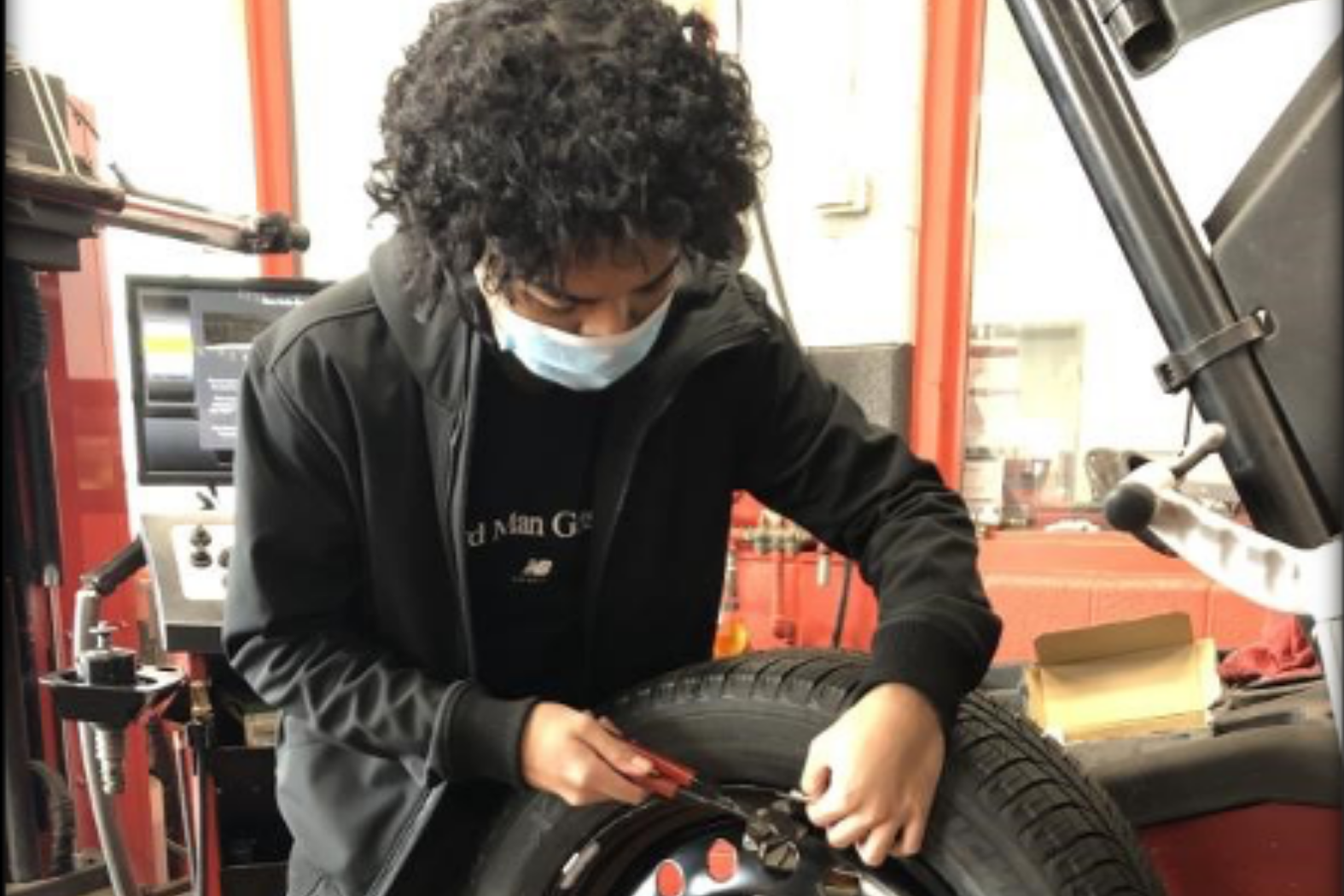 student with car tire