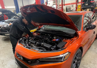 student working on car