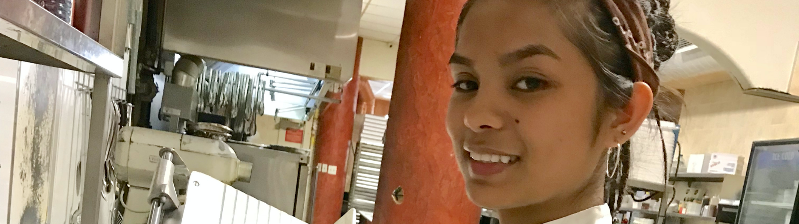 student smiling in kitchen