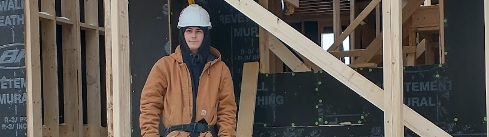 student standing in framed building