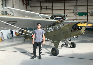 student standing in front of plane