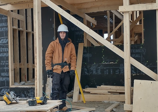 student standing in framed building