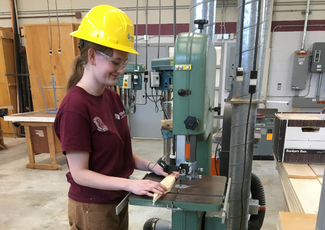 student working with saw