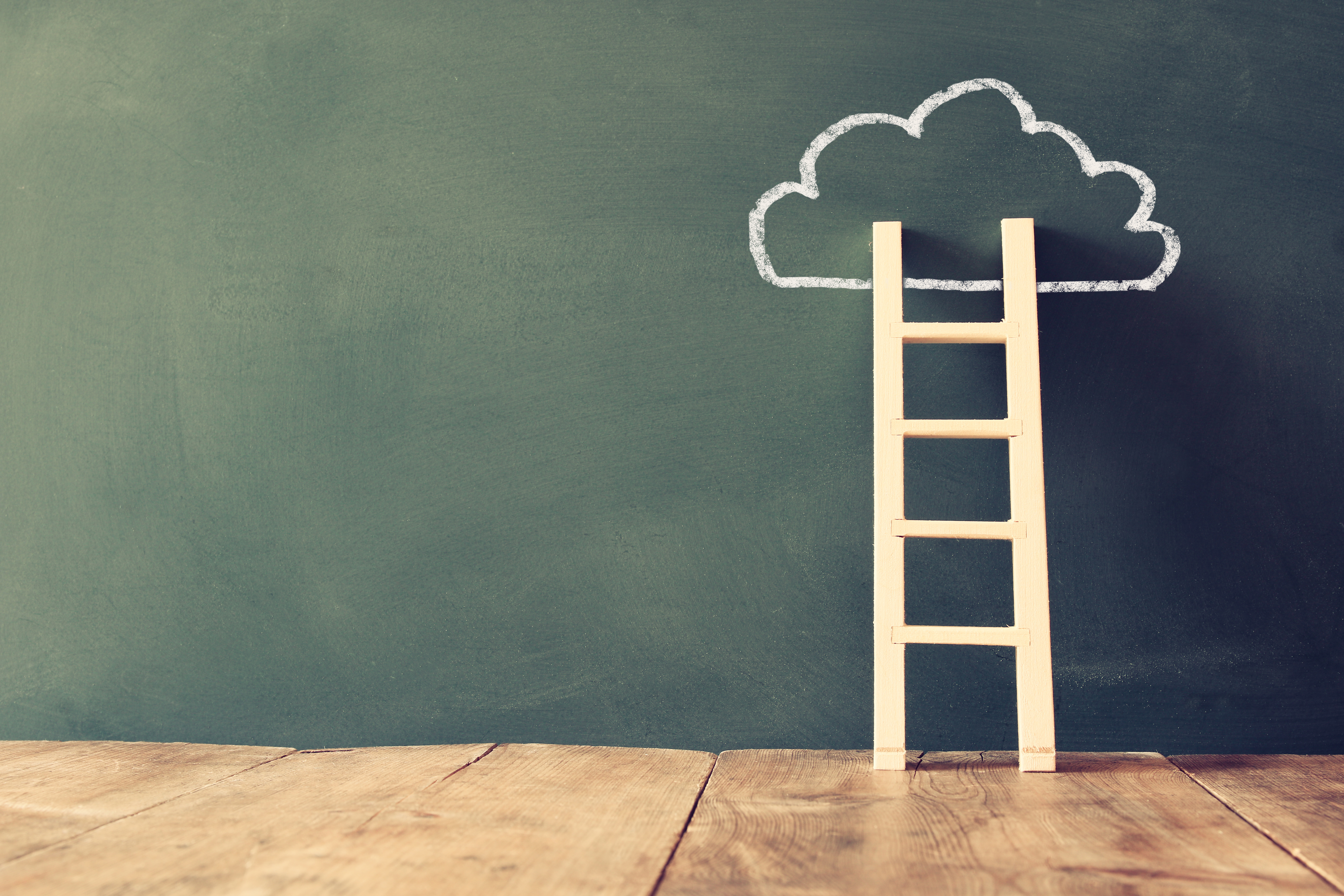 Ladder against chalkboard