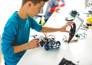 male students working on robotics