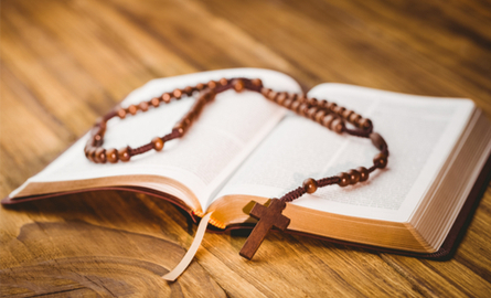 Open bible with rosary on top