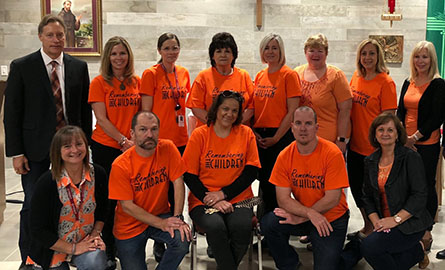 Staff wearing orange shirts