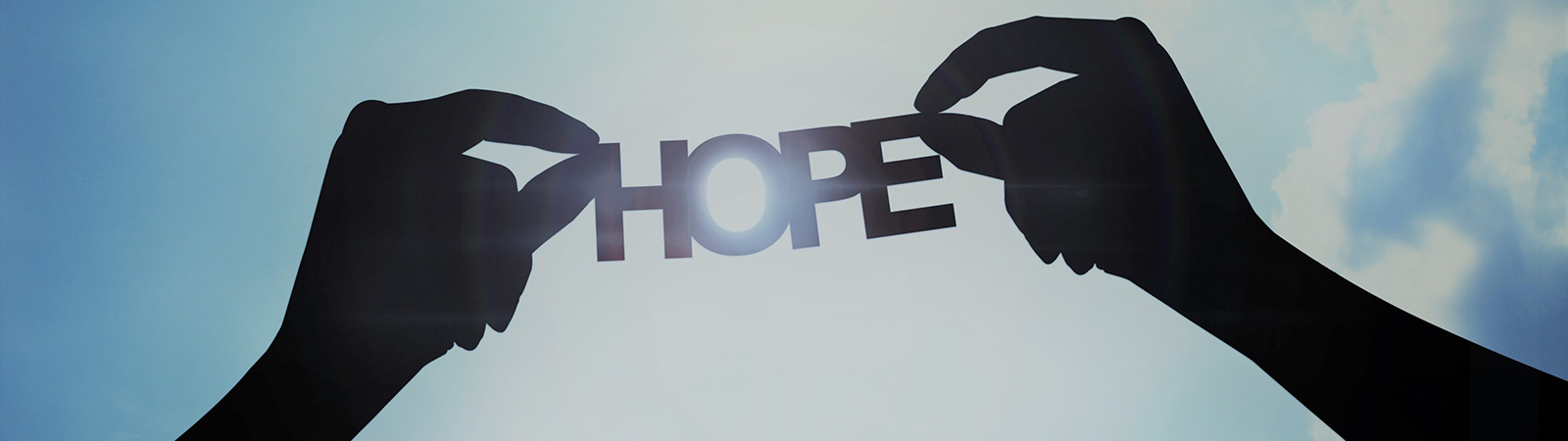 Hands holding up letters that spell Hope