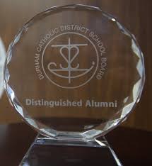 Photograph of the award - a glass circle with the title engraved on it