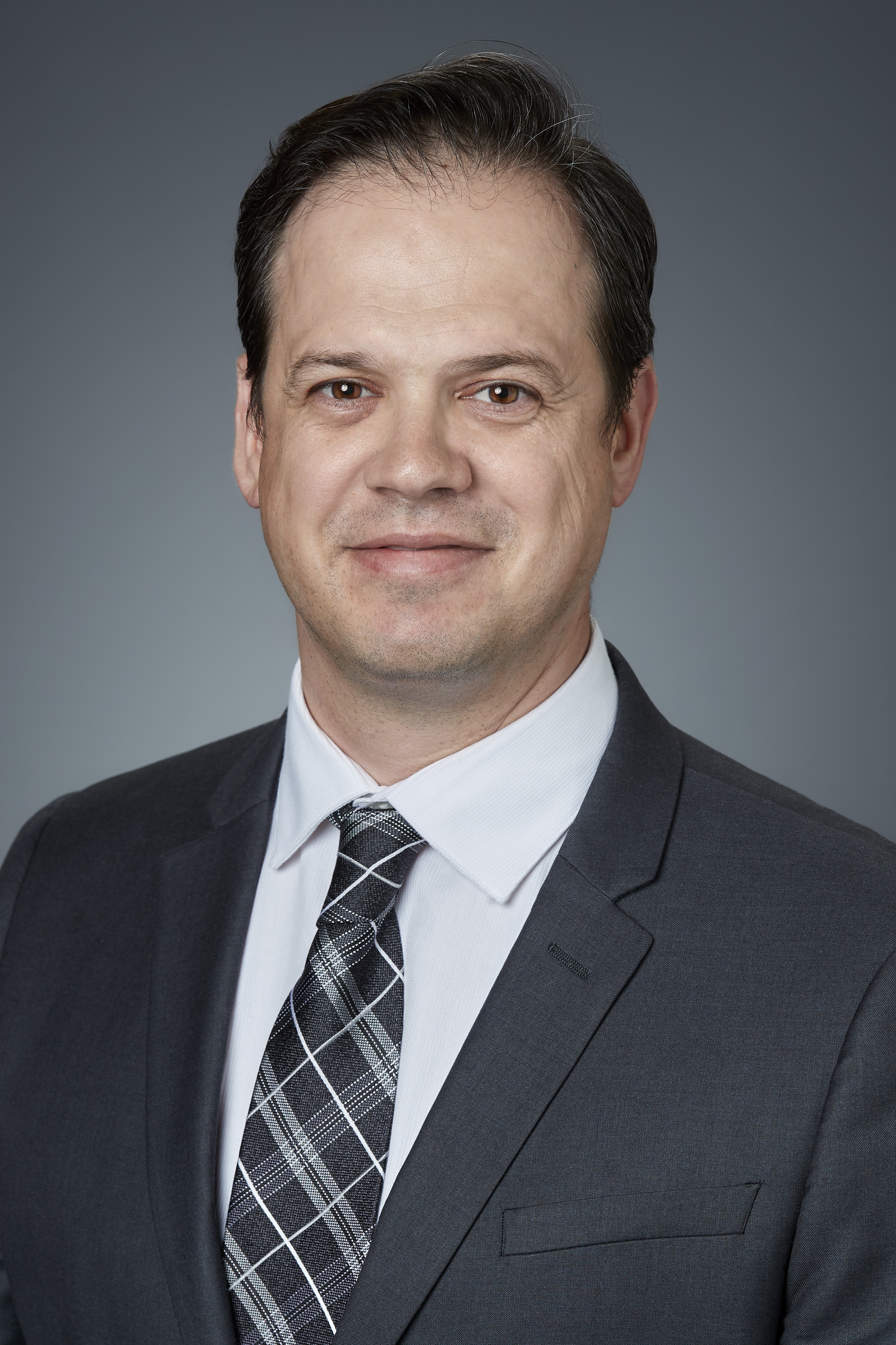 photograph of Robert, smiling wearing a suit