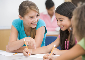 Three girls talking in class