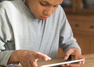 Male student on an ipad