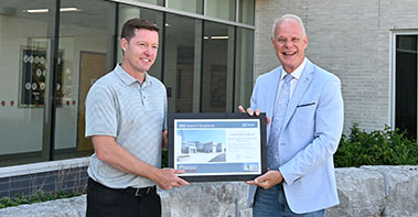 Mayor of Oshawa handing Superintendent the Urban  Design Award