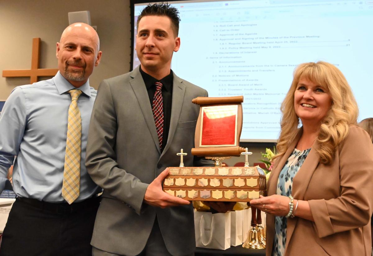 Principal with Trustee and School Administrative Assistant receiving the Rev. John Markle Award