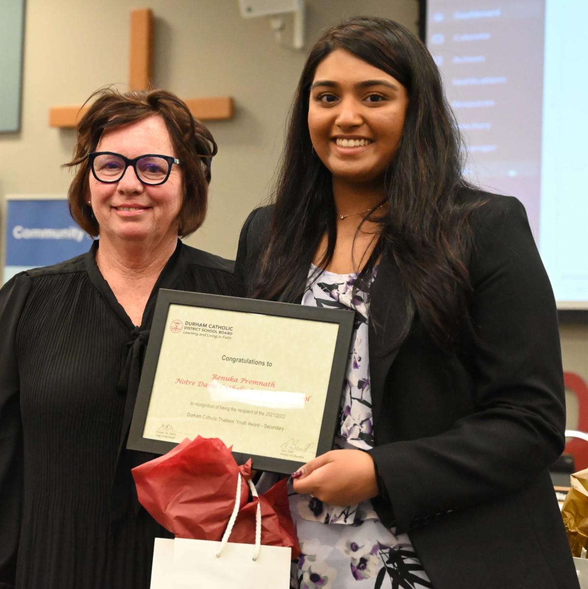 Trustee Oldman present Trustee Youth award to female student