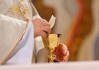 Priest holding the Eucharist  