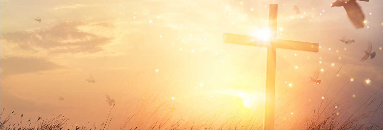 Cross in the sunlight with doves flying around