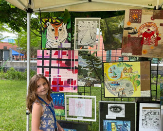 Female student standing beside her artwork