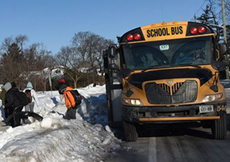 Students coming off a school bus