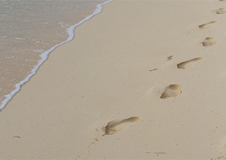 water and footprints in the sand