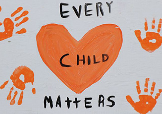 Orange hand prints and heart Every Child Matters
