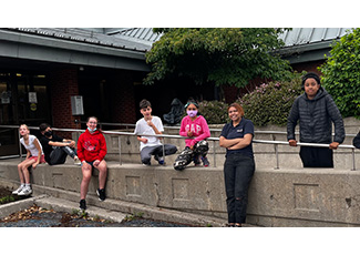 Indigenous students with artists standing outside of board office