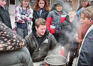 Students watching sap boiling outside