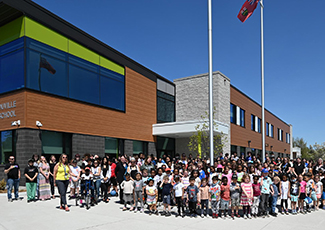 Students and staff standing outside of school