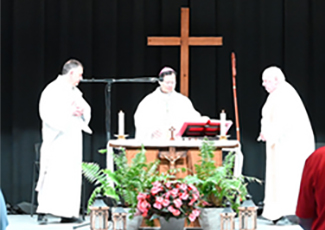 Deacon standing with Bishop Nguyen and Father Callaghan for Mass