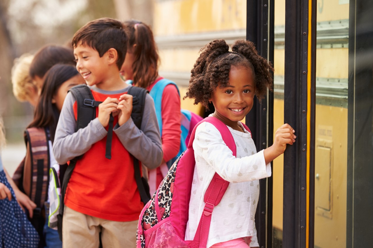 Female student going on a school bus