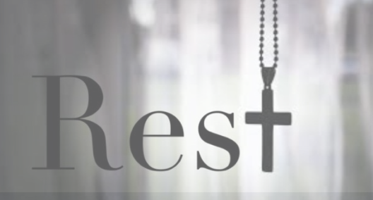 the word rest in serif typeface and the t is shaped as a wooden cross