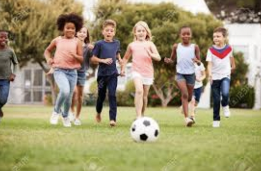 group of children playing soccer