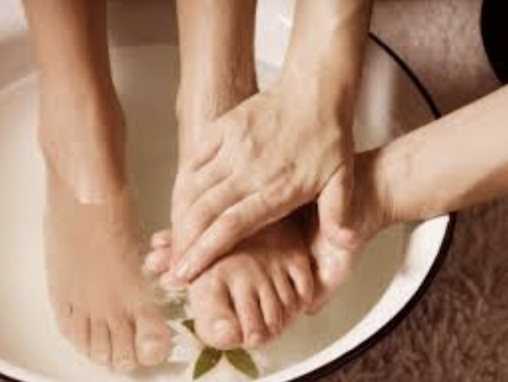 feet being washed in a bowl