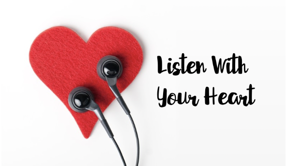 a red felt heart with headphones against it. Text to the right reads listen to your heart