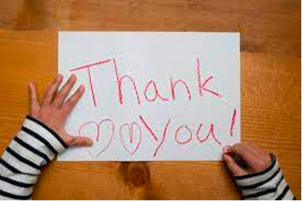 a white sheet of paper with the words Thank You written in red crayon