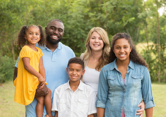 family standing together and smiling