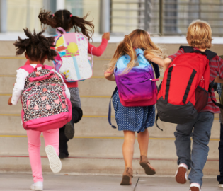 children running with backpacks