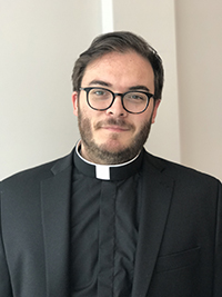 male adult priest smiling