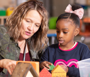 Teacher helping a kindergarten student