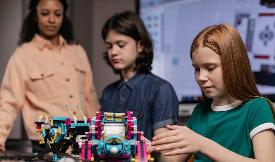 Young girls using robotics